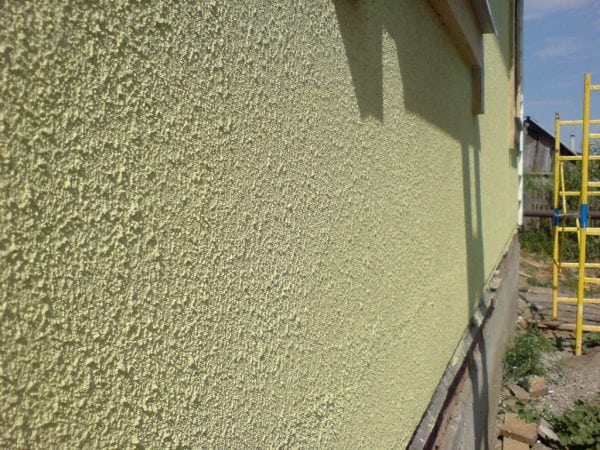 The concrete facade of the building is painted with textured paint