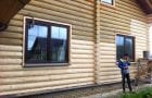 A man paints a blockhouse