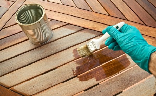 Putting drying oils on a tree with a brush