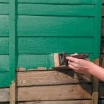 Painting the walls of a wooden house