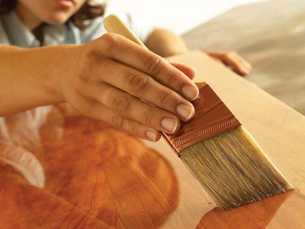 Brush coating plywood with drying oil