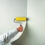 Wallpapering on a painted wall