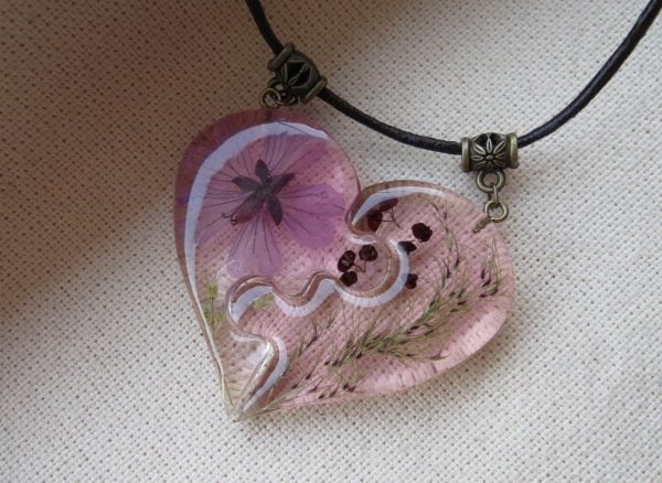 Heart shaped pendant with resin jewelry geranium flower