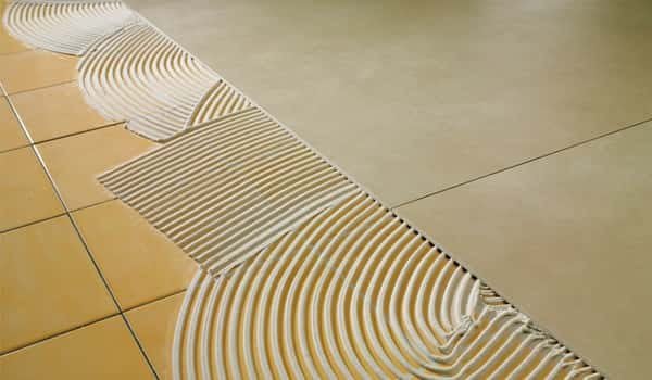 Two-component adhesive suitable for laying tiles in a second layer