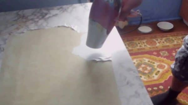 Removing self-adhesive film from furniture