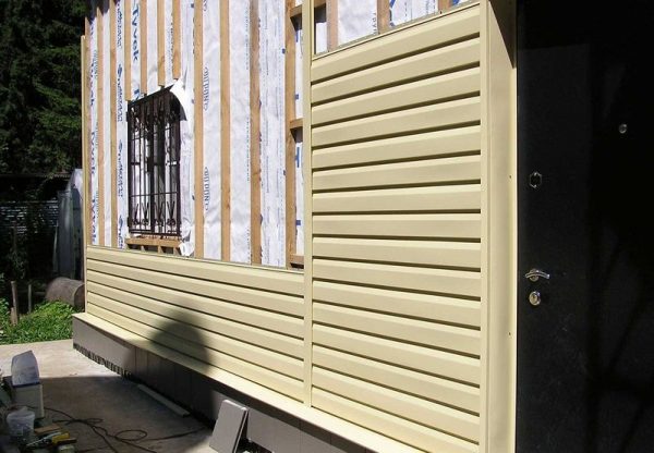 The house is sheathed with wooden clapboard