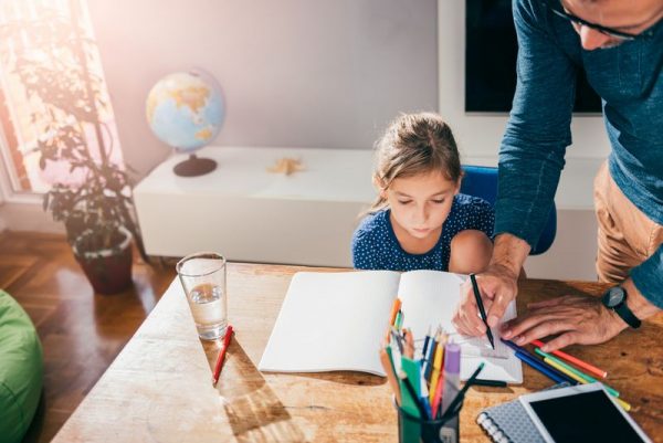 A girl in her room does homework