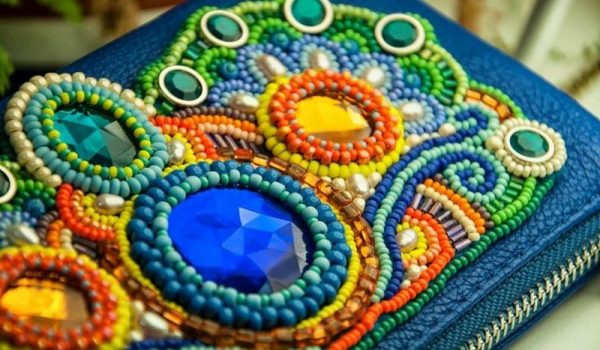 A wallet embroidered with beads and stones