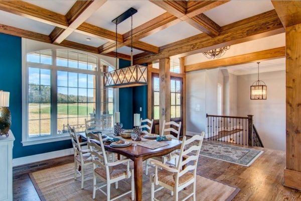 Room interior with wooden columns and beams.