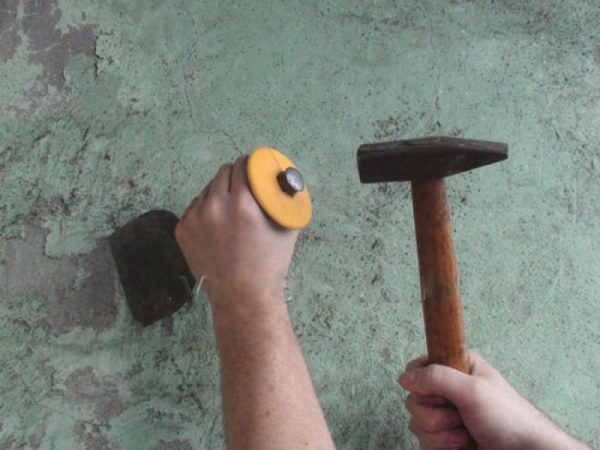 Removing the plaster with a hatchet with a hand tool