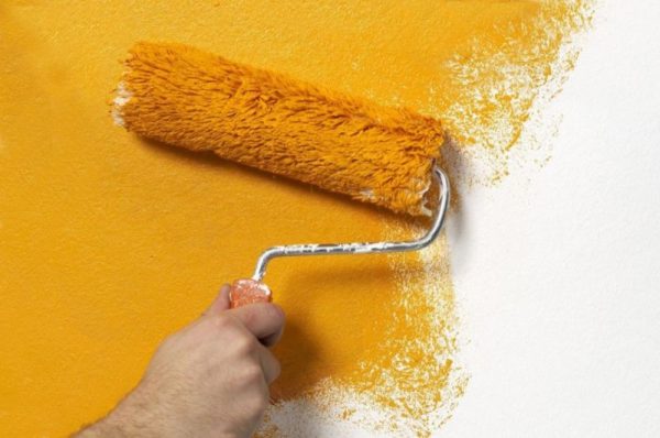 Paint the wall with a roller in yellow